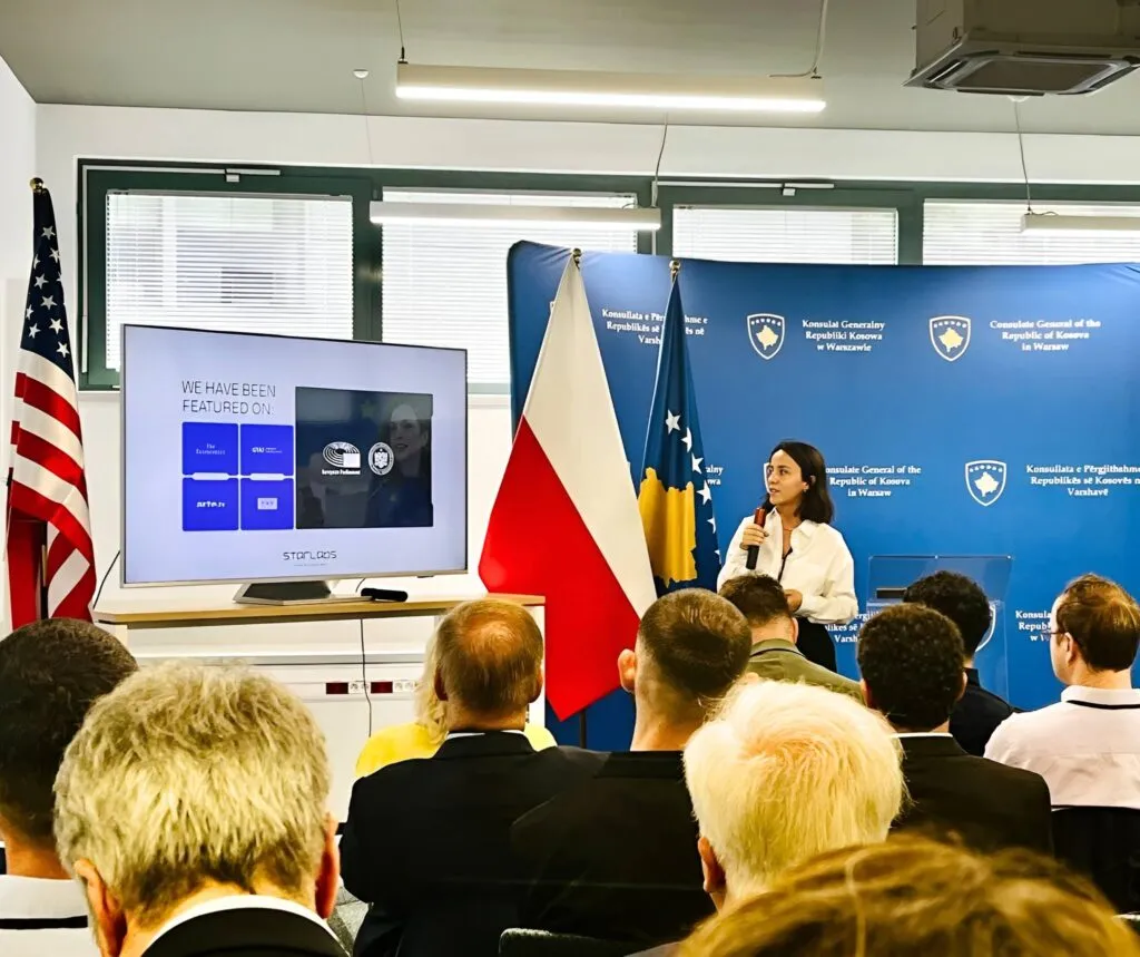 Hana Qerimi presents StarLabs at the Consulate General of Kosovo in Warsaw, between the Polish and Kosovo flags