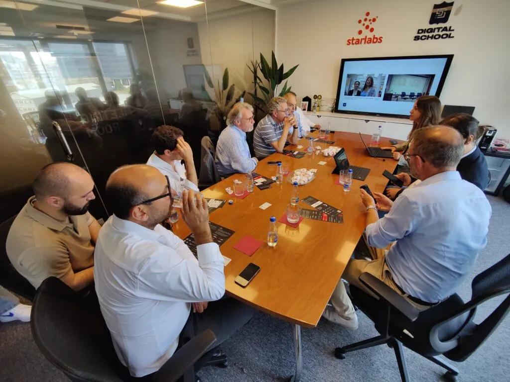 The meeting around the boardroom table, the StarLabs and Digital School logos on the wall